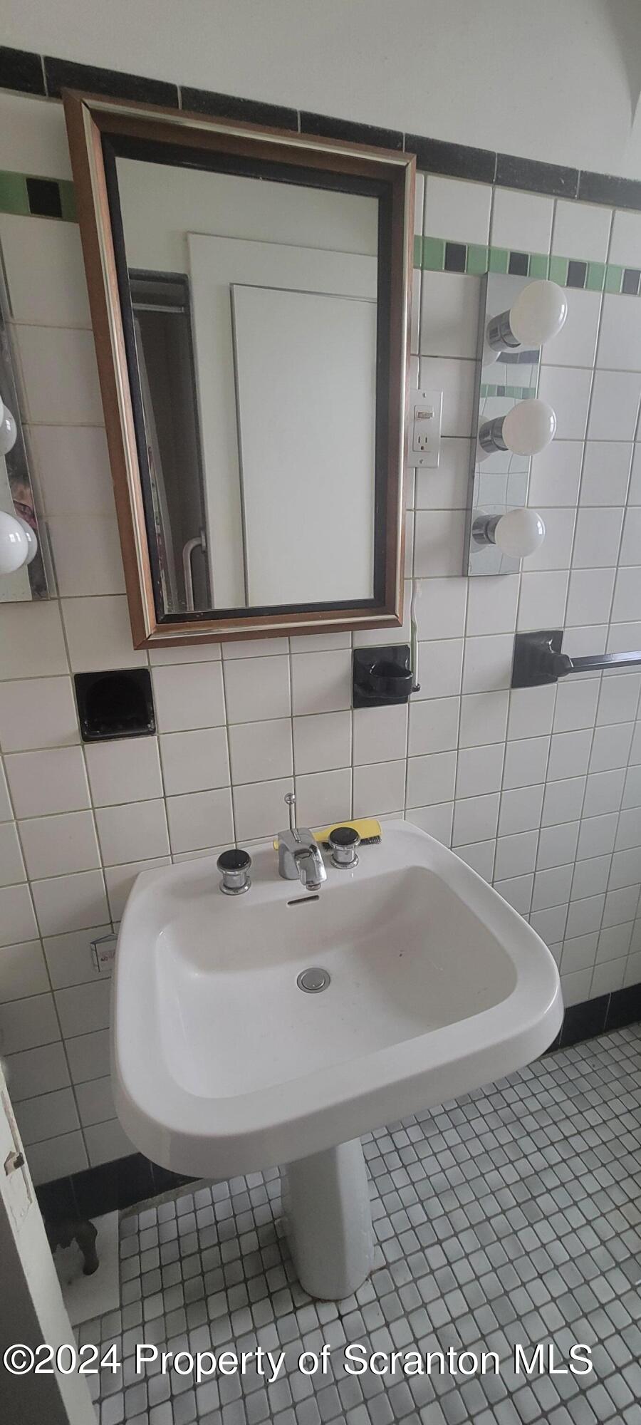 1543 Capouse Avenue Scranton, PA 18509 - Photo 12 of 62 a bathroom with a sink and a mirror