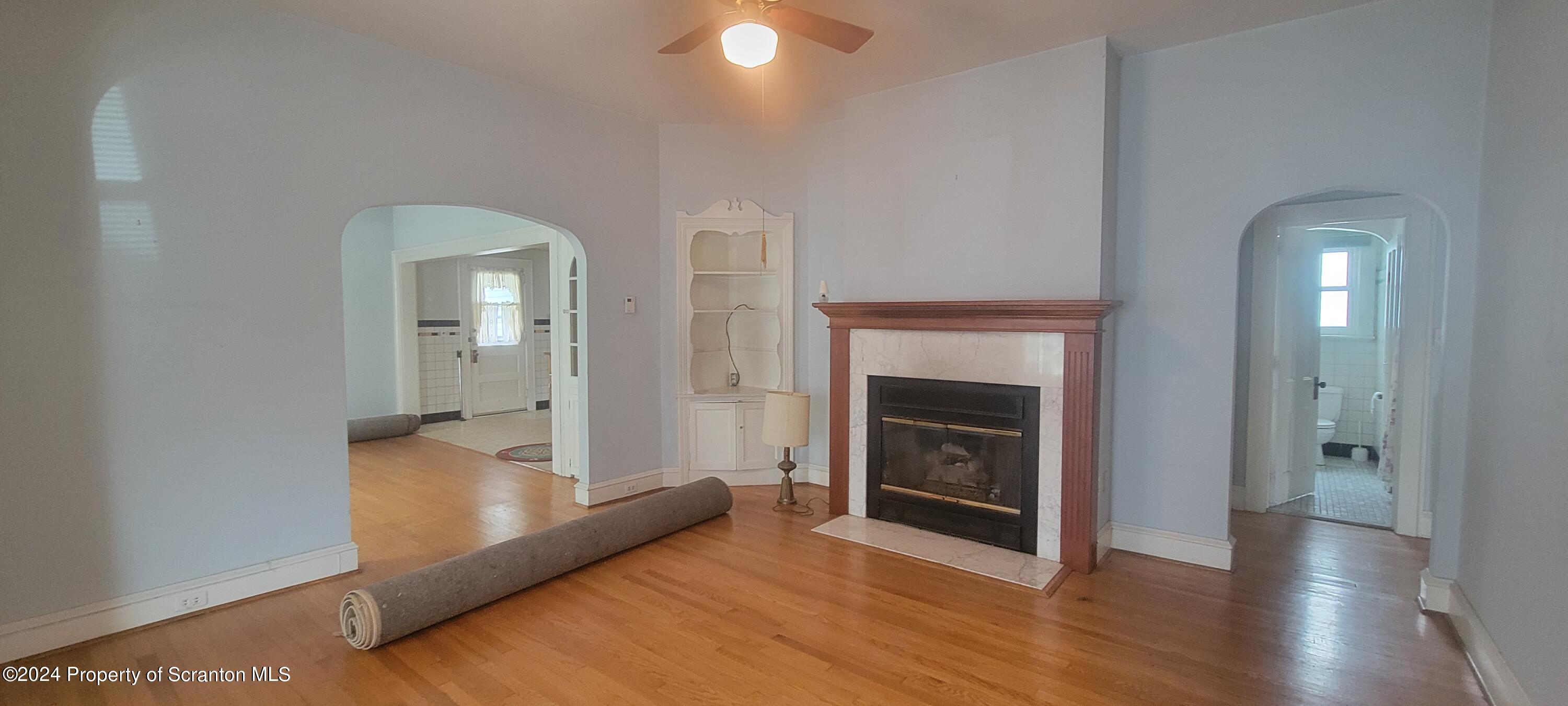 1543 Capouse Avenue Scranton, PA 18509 - Photo 16 of 62 a view of a livingroom with wooden floor and a fireplace