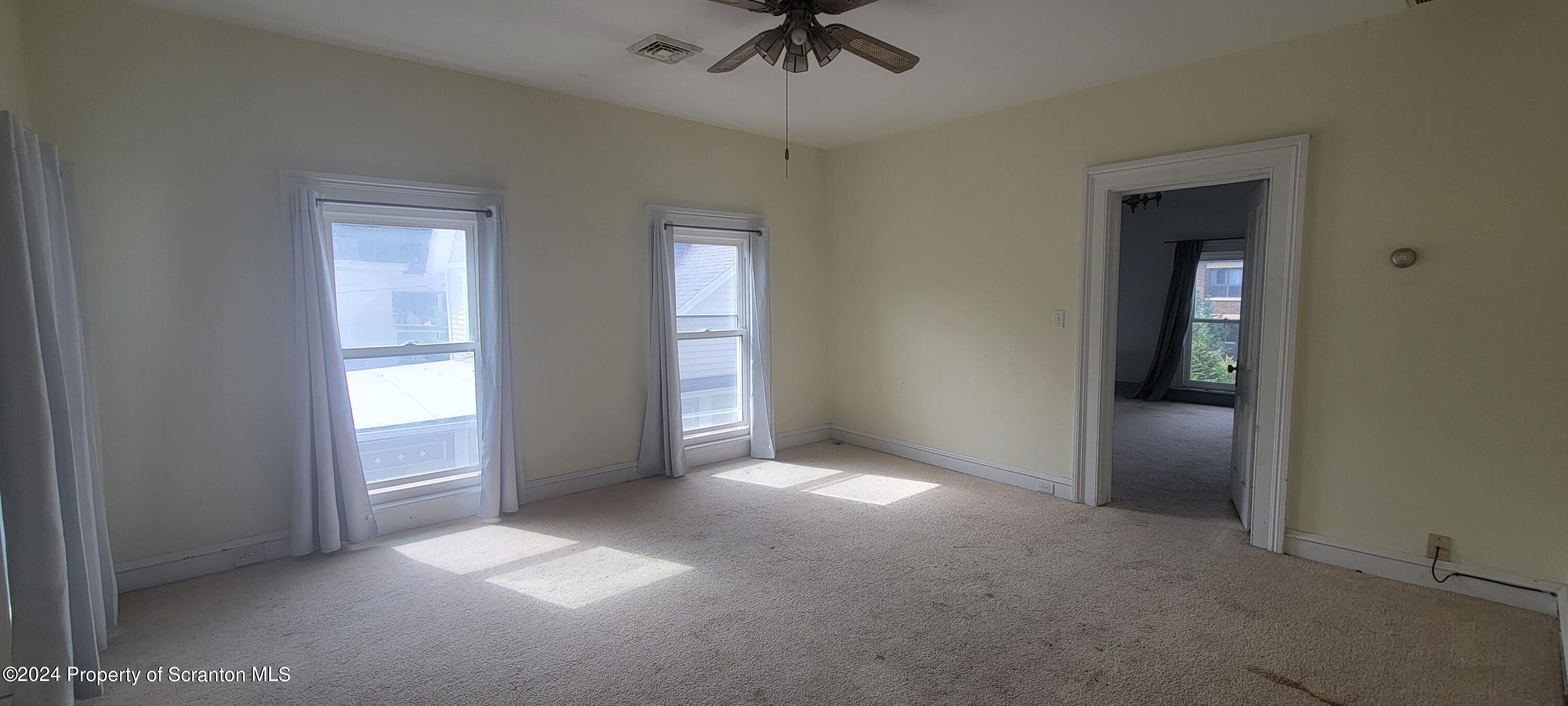 1543 Capouse Avenue Scranton, PA 18509 - Photo 29 of 62 an empty room that has a window and kitchen view