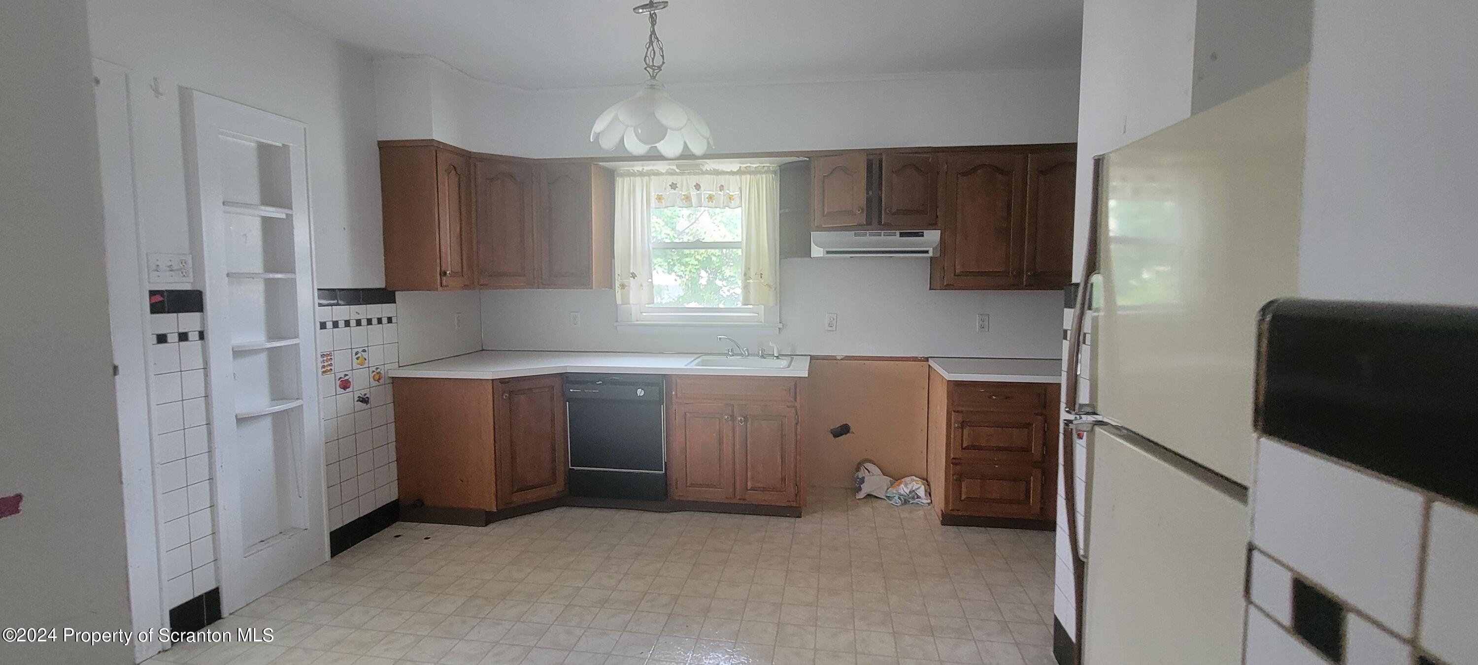 1543 Capouse Avenue Scranton, PA 18509 - Photo 32 of 62 a kitchen with cabinets and window