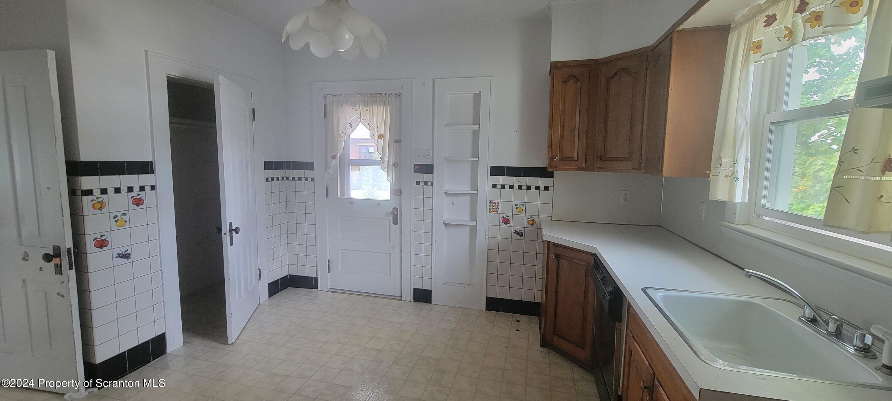 1543 Capouse Avenue Scranton, PA 18509 - Photo 33 of 62 a kitchen with a refrigerator and a sink