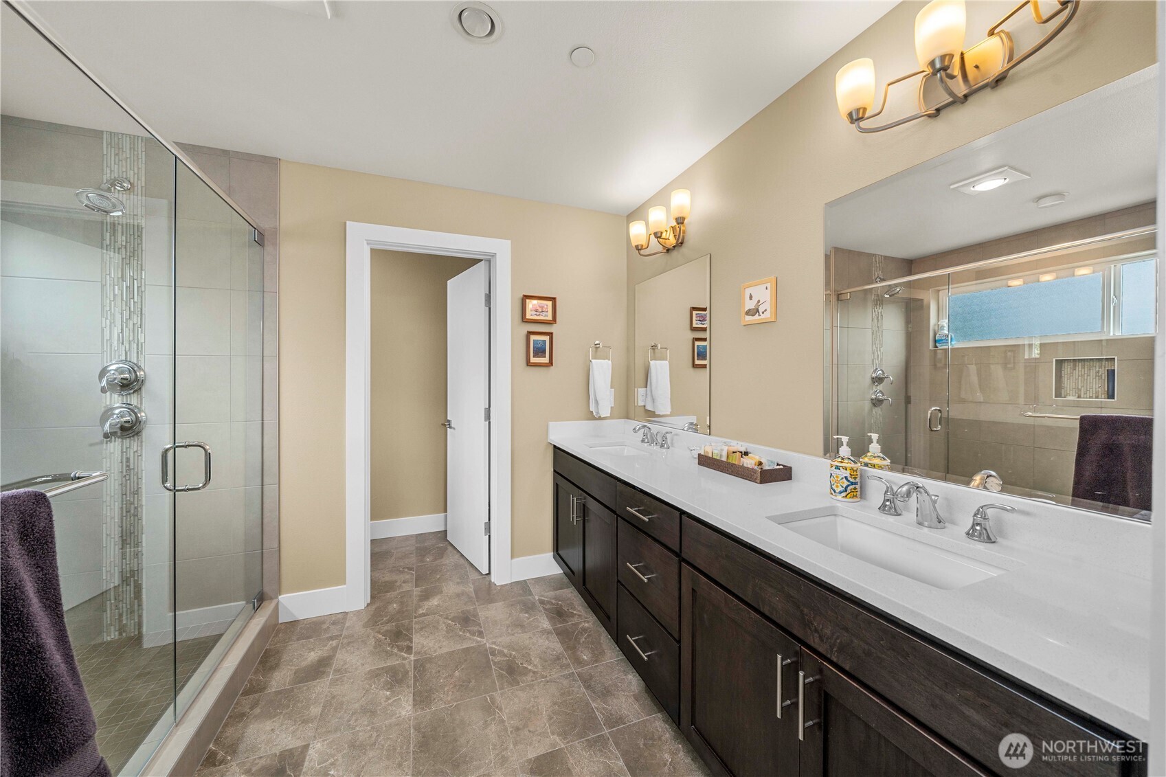 9710 Main Street, Unit A Bothell, WA 98011 - Photo 7 of 7 a spacious bathroom with a double vanity sink a large mirror and a shower