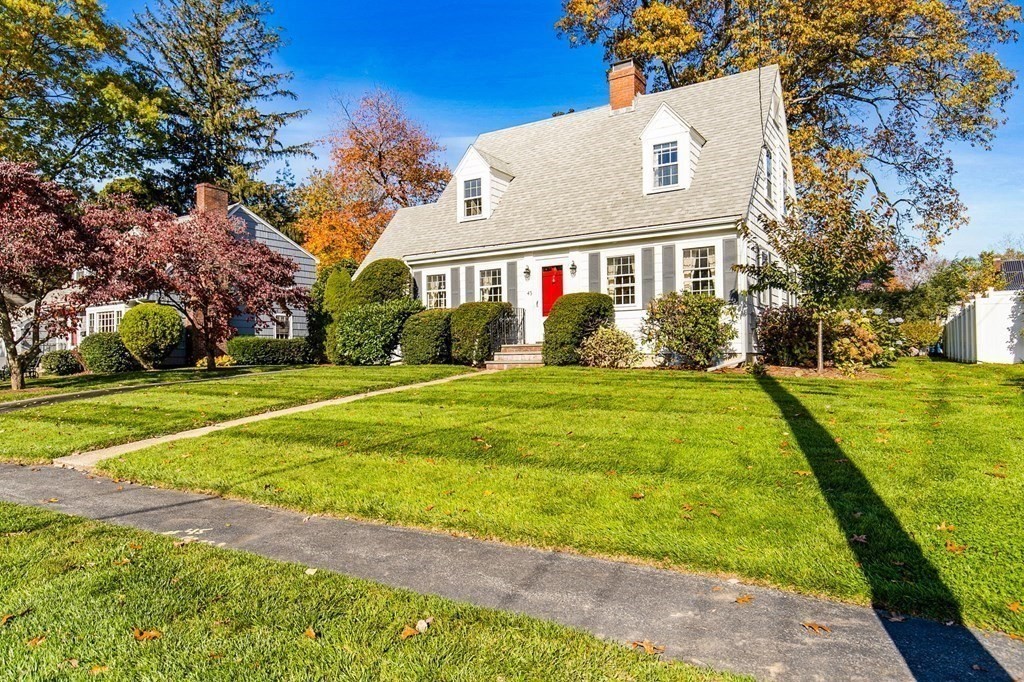 45 Longfellow Road Needham, MA 02494 - Photo 12 of 20 a view of a white house with a big yard and potted plants