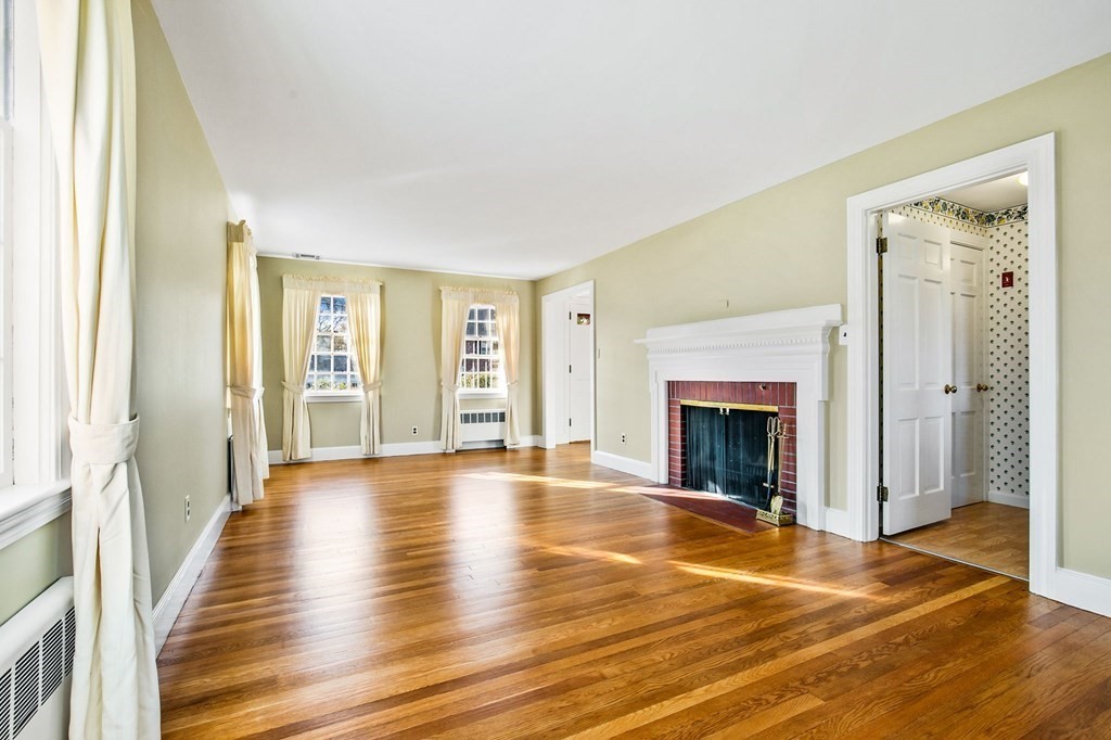 45 Longfellow Road Needham, MA 02494 - Photo 5 of 20 a view of an empty room with wooden floor and a window
