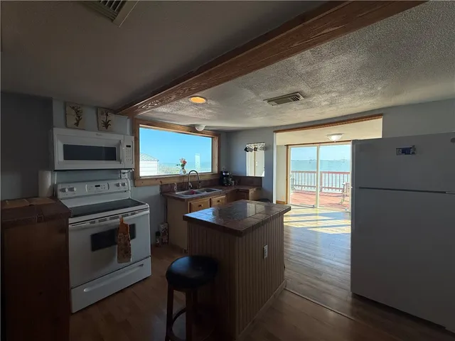 a kitchen with a stove a sink and a refrigerator