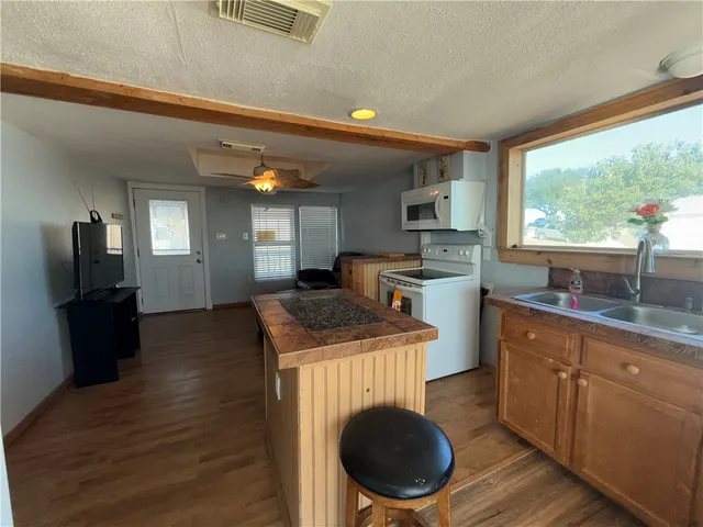 a kitchen with a stove a sink and a refrigerator