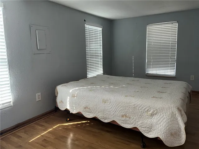 a bed sitting in a bedroom next to a window