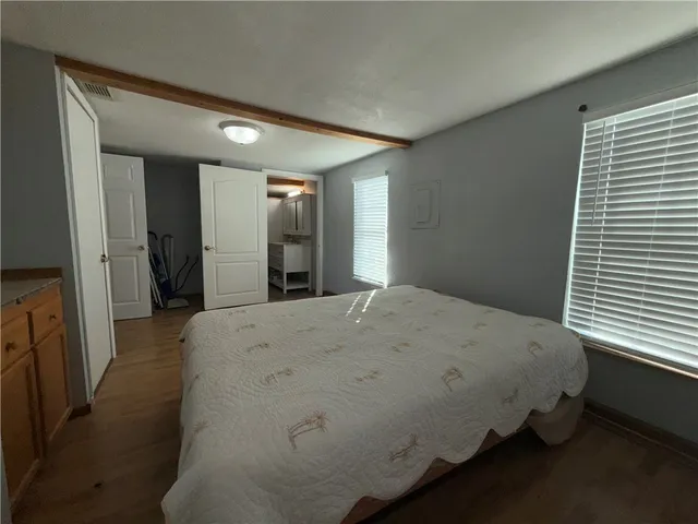 a bedroom with a bed and a dresser