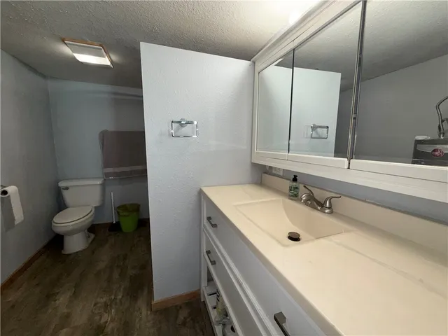 a bathroom with a sink toilet and mirror