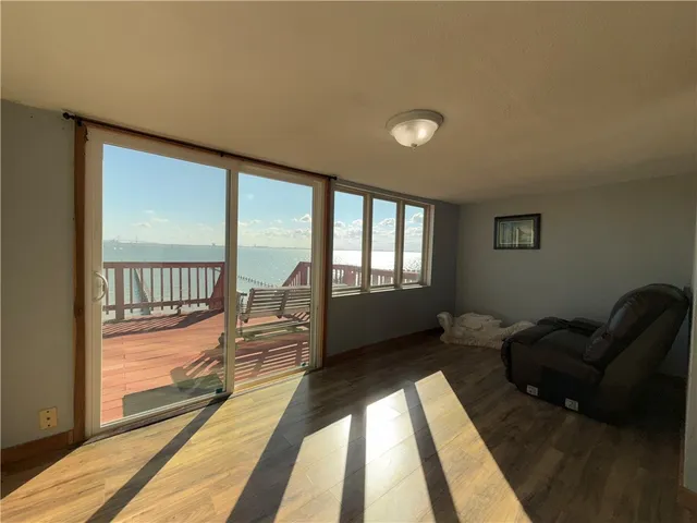 a view of a room with furniture and a large window