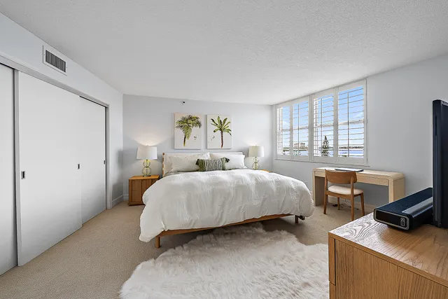 a bedroom with a bed and a desk