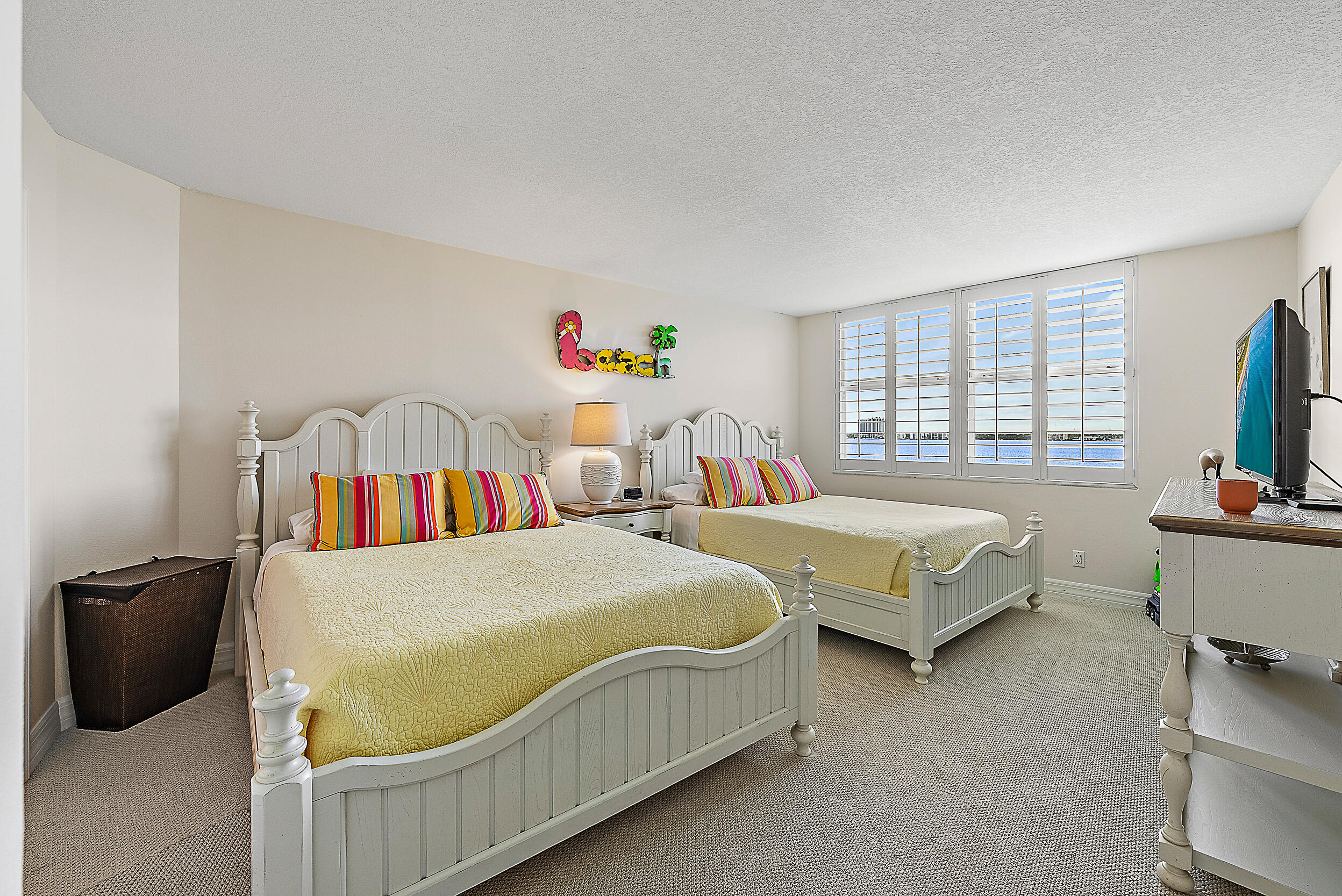 5200 North Ocean Drive, Unit 505 Singer Island, FL 33404 - Photo 18 of 30 a bedroom with two beds and a flat screen tv