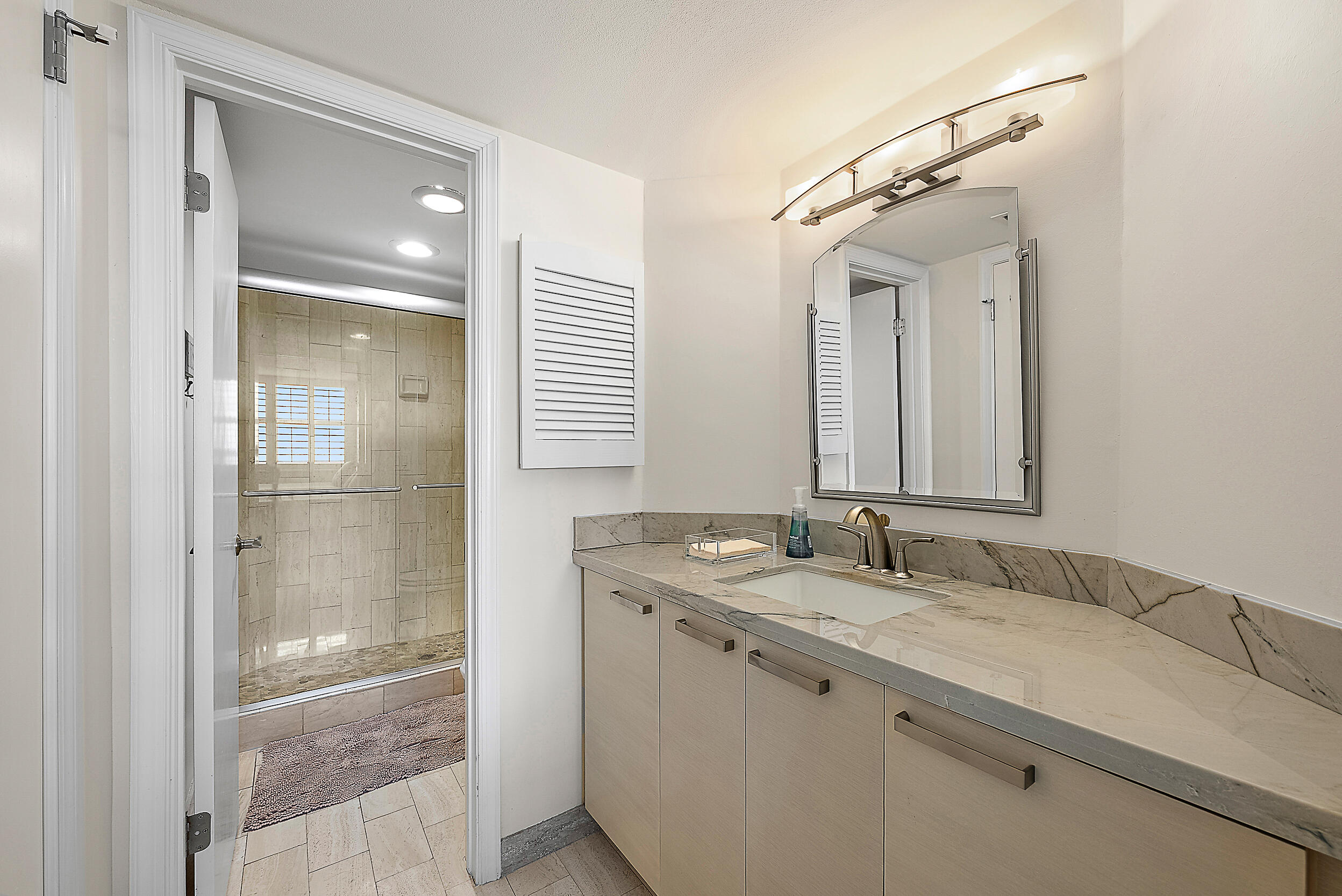 5200 North Ocean Drive, Unit 505 Singer Island, FL 33404 - Photo 19 of 30 a bathroom with a granite countertop sink and a mirror