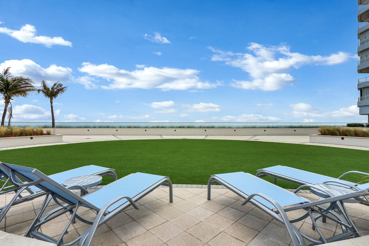 5200 North Ocean Drive, Unit 505 Singer Island, FL 33404 - Photo 30 of 30 a view of a chairs and table in the garden