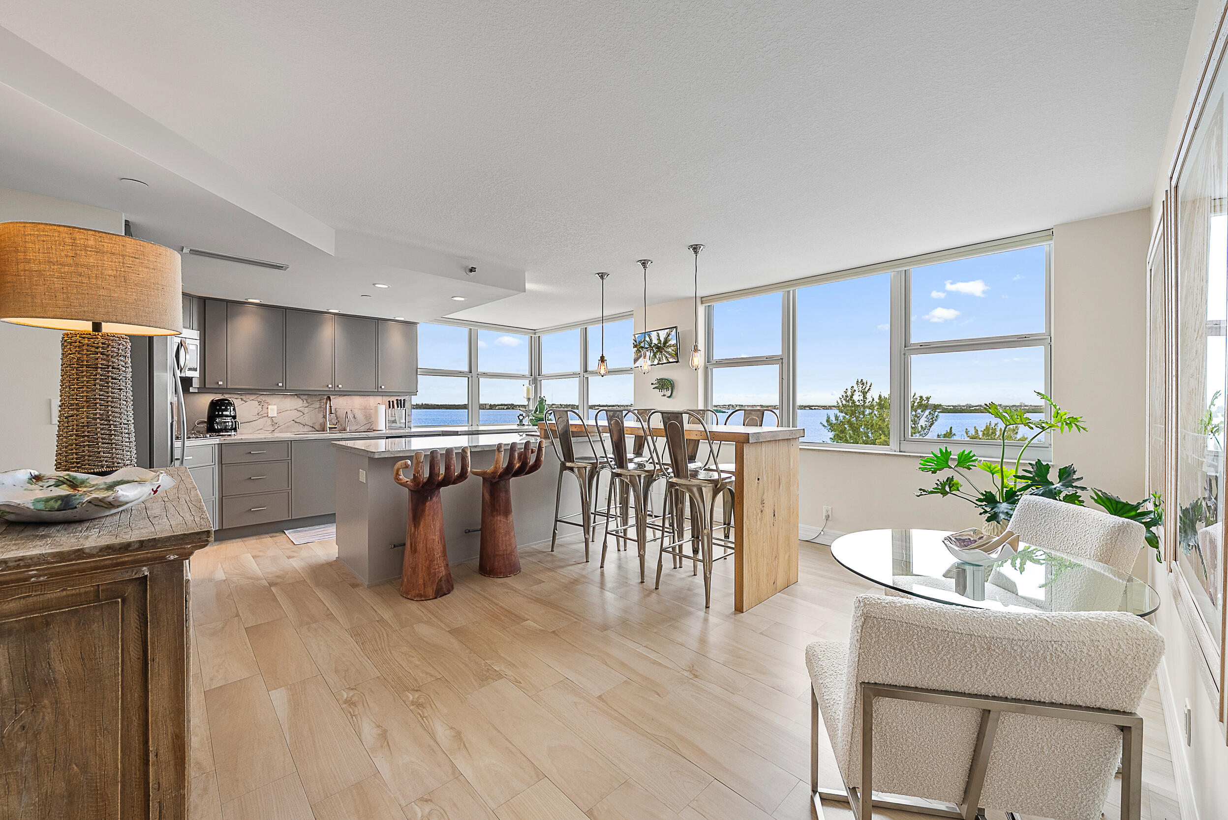 5200 North Ocean Drive, Unit 505 Singer Island, FL 33404 - Photo 6 of 30 a kitchen with a table chairs refrigerator and microwave