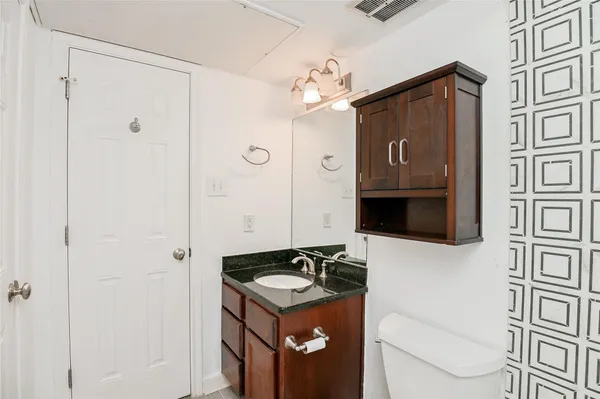 a bathroom with a sink a mirror and a shower
