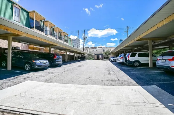 a view of a cars park in front of a building