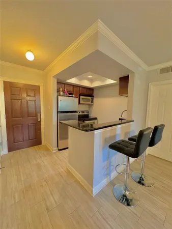 a kitchen with stainless steel appliances kitchen island a refrigerator and a stove top oven