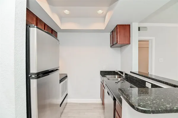 a kitchen with a sink and a refrigerator