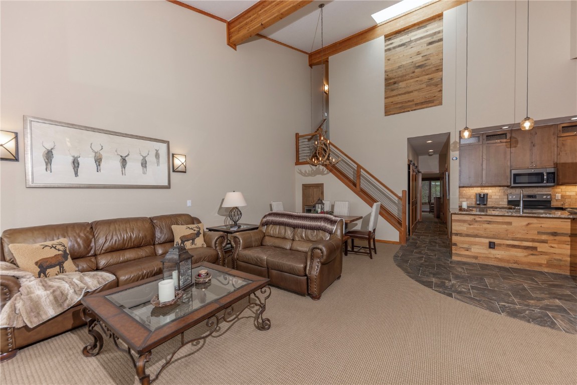 21630 Highway 6, Unit 2145 Keystone, CO 80435 - Photo 11 of 39 a living room with furniture and a kitchen view