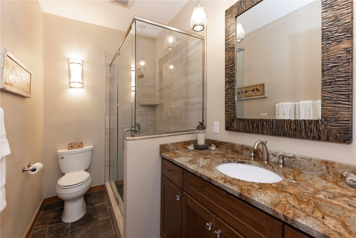 21630 Highway 6, Unit 2145 Keystone, CO 80435 - Photo 23 of 39 a bathroom with a granite countertop sink toilet and shower