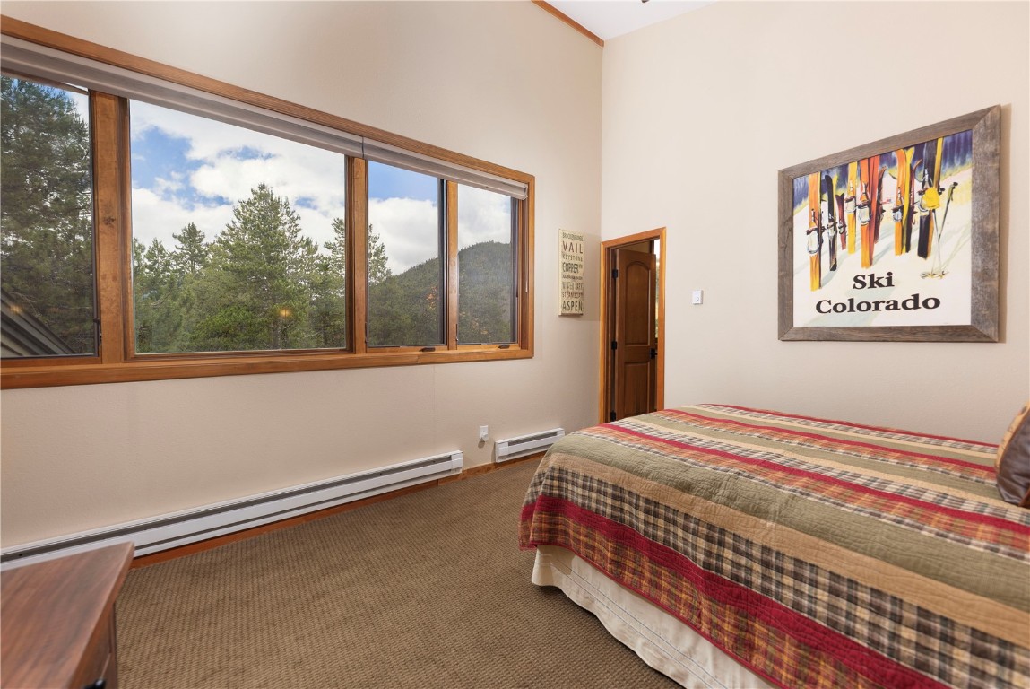21630 Highway 6, Unit 2145 Keystone, CO 80435 - Photo 26 of 39 a bedroom with a bed and a large window