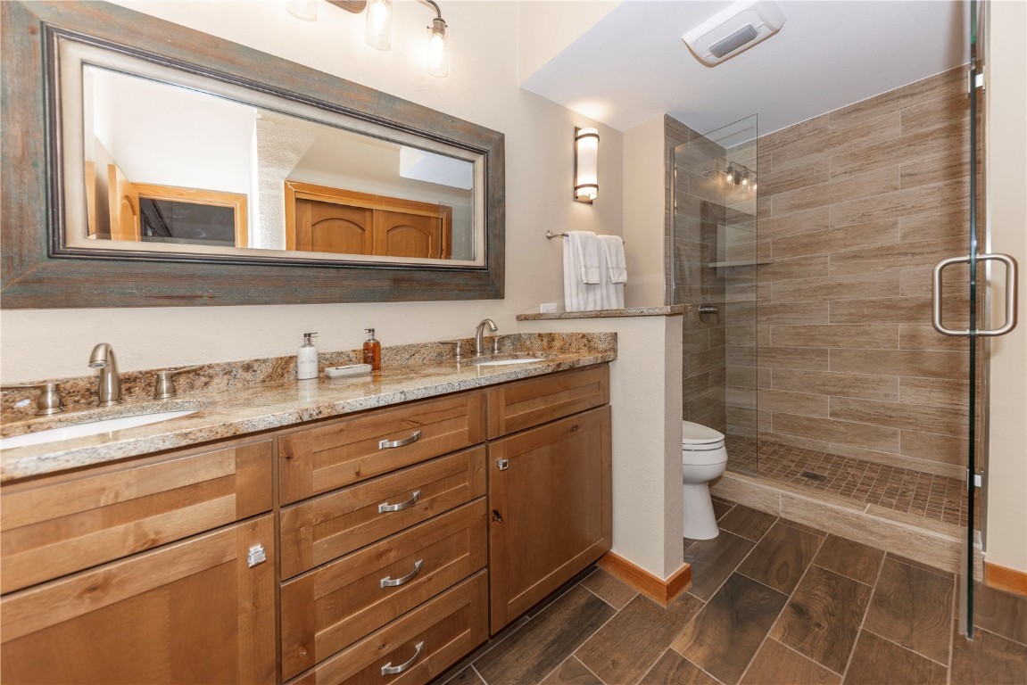 21630 Highway 6, Unit 2145 Keystone, CO 80435 - Photo 27 of 39 a bathroom with a granite countertop sink toilet and shower