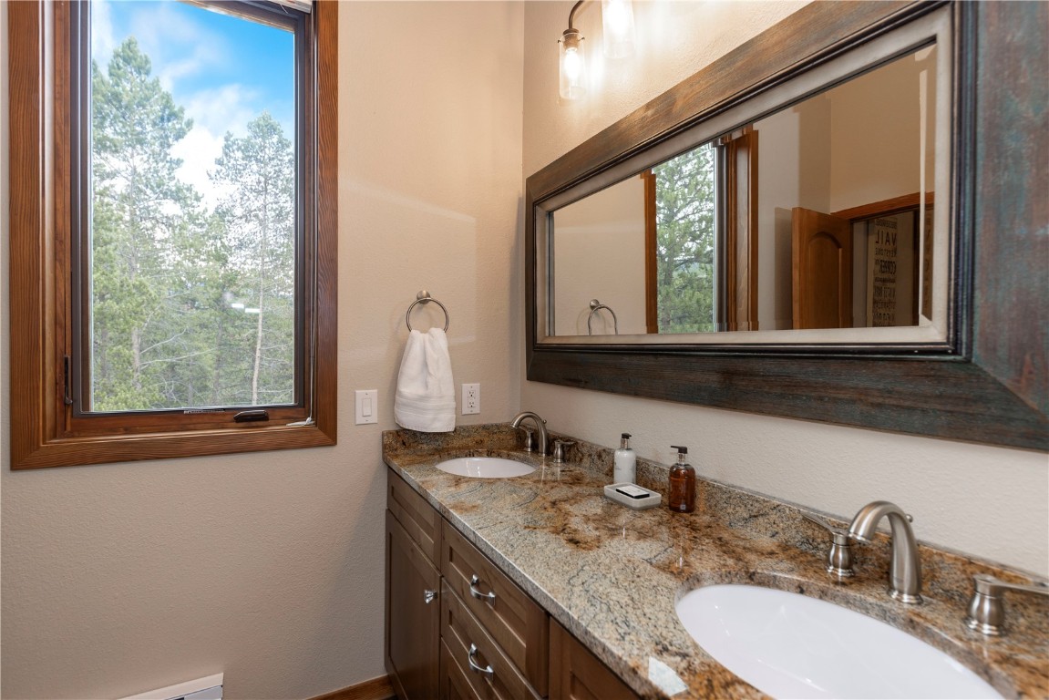 21630 Highway 6, Unit 2145 Keystone, CO 80435 - Photo 28 of 39 a bathroom with a granite countertop sink and a mirror