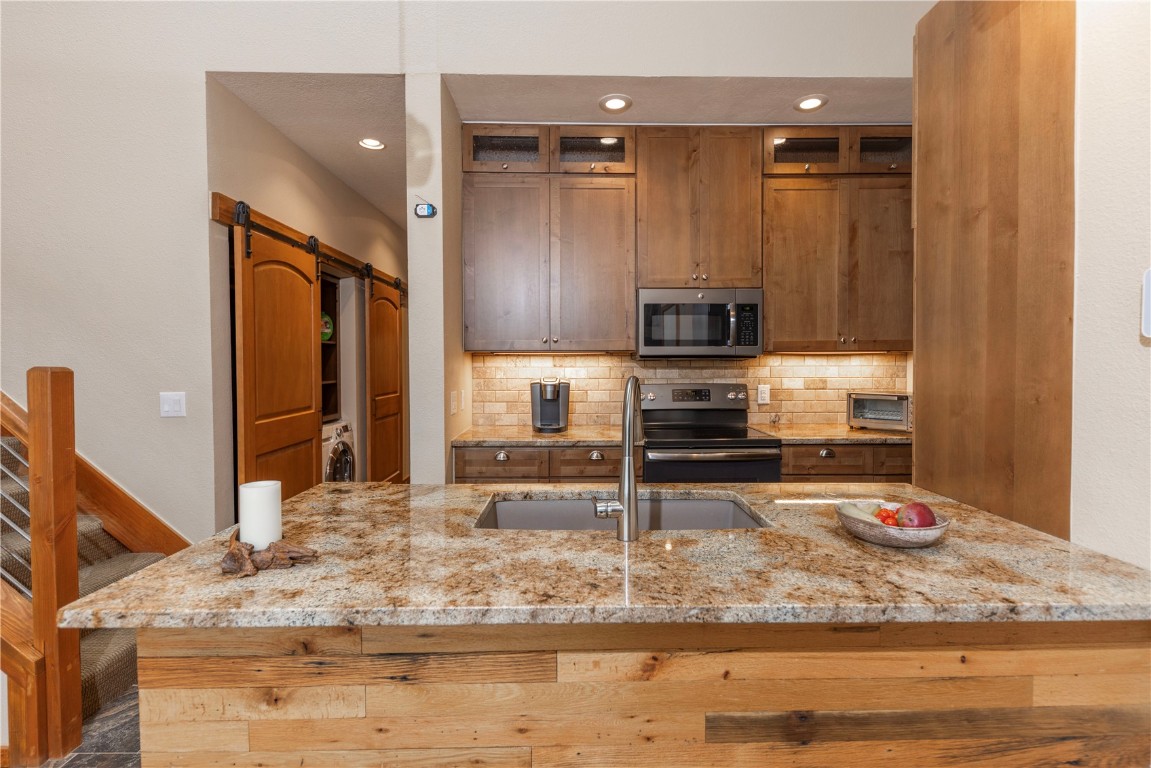 21630 Highway 6, Unit 2145 Keystone, CO 80435 - Photo 8 of 39 a kitchen with a refrigerator stove and a sink