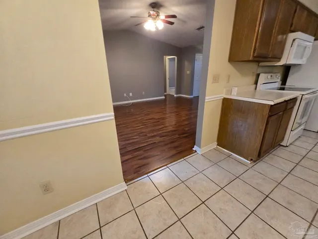 a view of an empty room and wooden floor