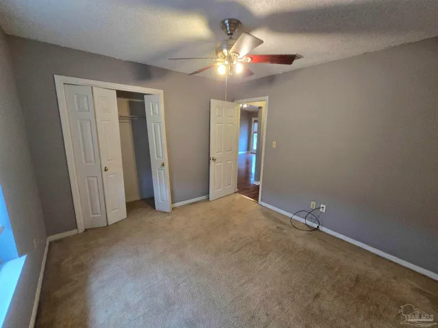 a view of a livingroom with a chandelier fan