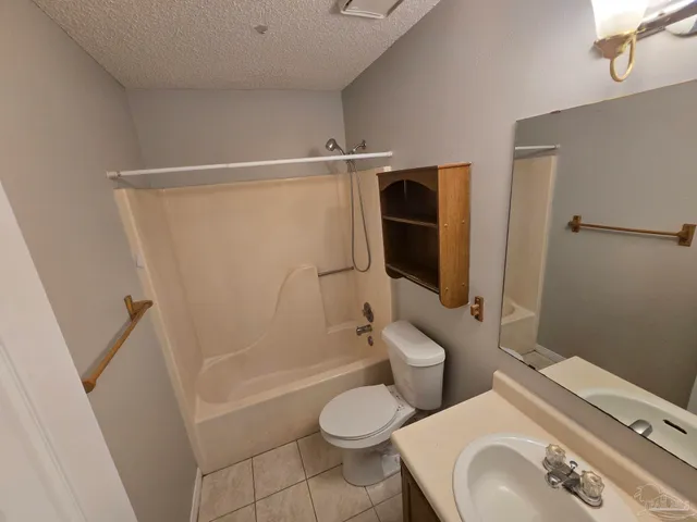 a white toilet sitting next to a bathroom sink and a shower