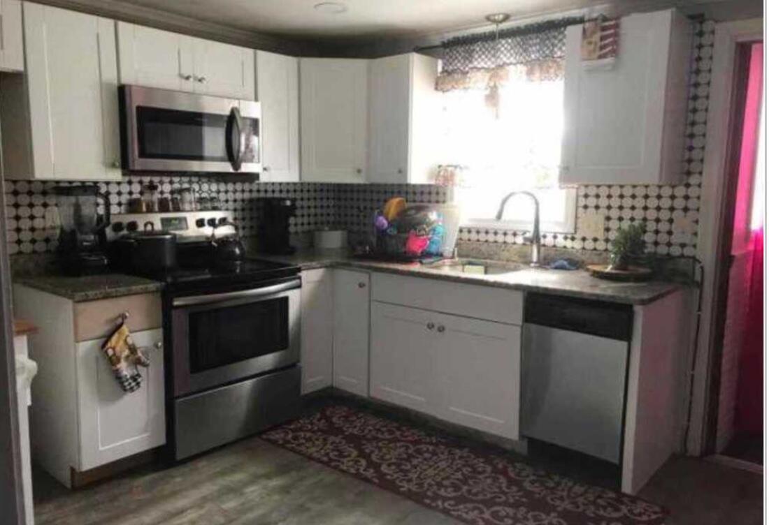 7 Ebenezer Road Osterville, MA 02655 - Photo 3 of 16 a kitchen with a sink stove and microwave