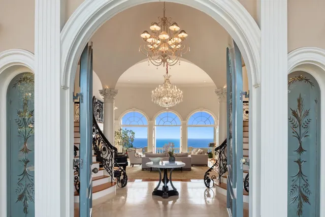 a view of a dining room with furniture chandelier and a chandelier