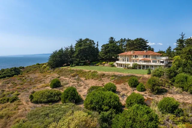 a view of a house with a lot of flower plants