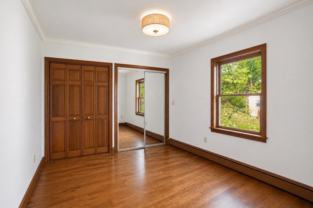 67 Wituwamat Road Weymouth, MA 02191 - Photo 22 of 42 a view of an empty room with wooden floor and a window