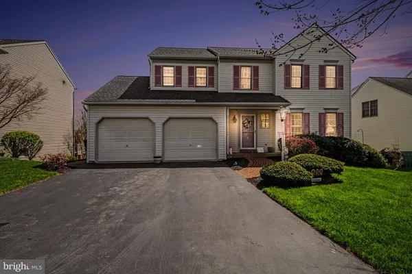 an outdoor living room with patio furniture and a garden