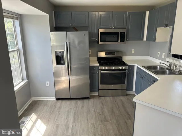 a kitchen with a refrigerator stove and microwave