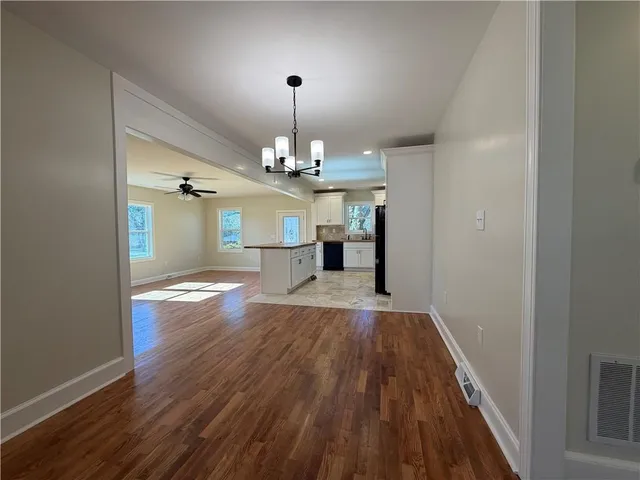 a view of livingroom with kitchen and hardwood floor