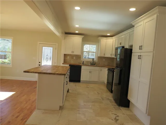 a kitchen with refrigerator and window