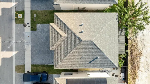 an aerial view of a house with a yard