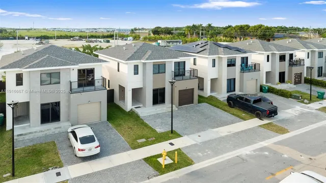 an aerial view of residential houses with outdoor space