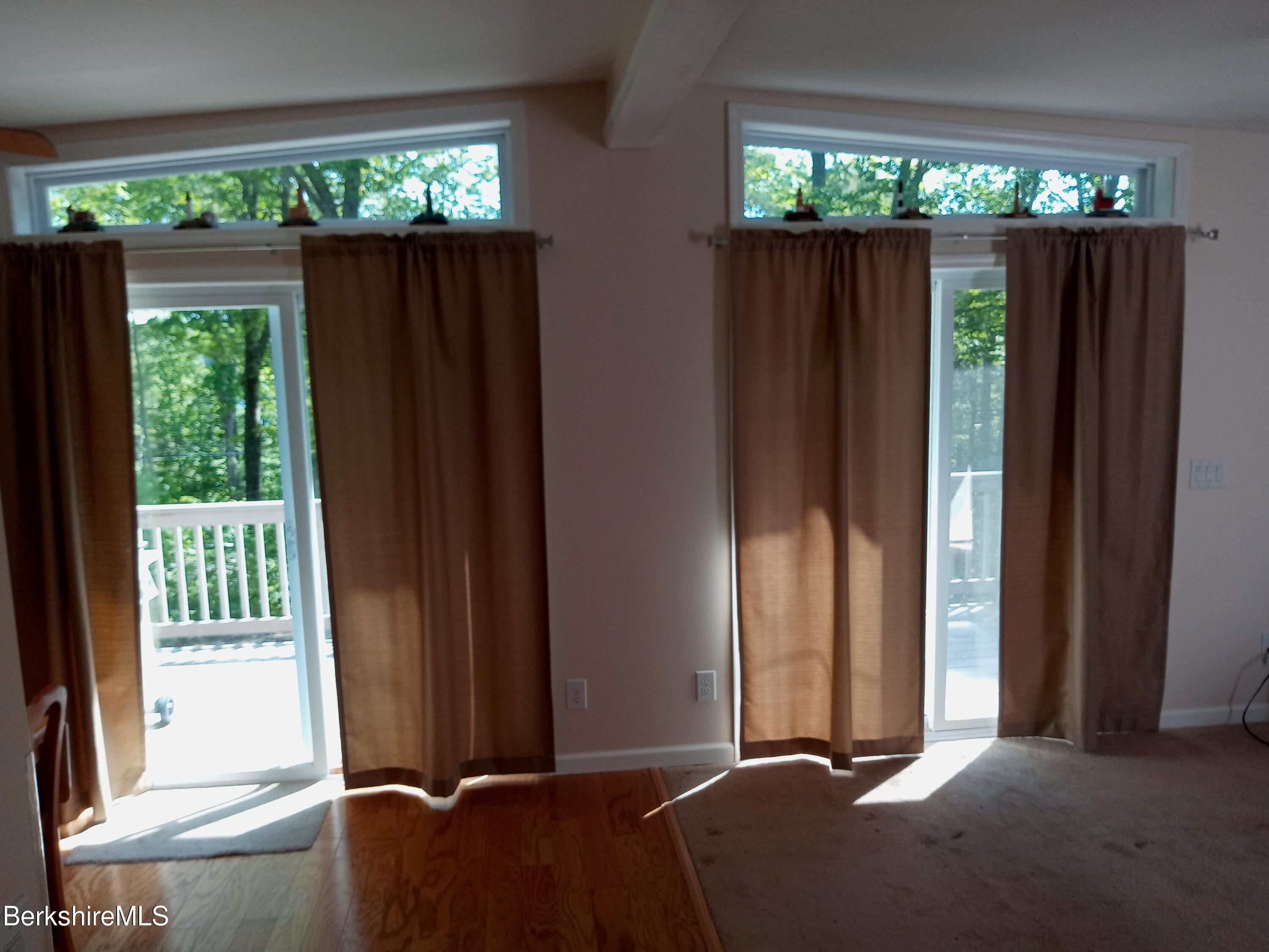 42 Norton Road Otis, MA 01029 - Photo 13 of 35 a bed room with a balcony a bed and a large window