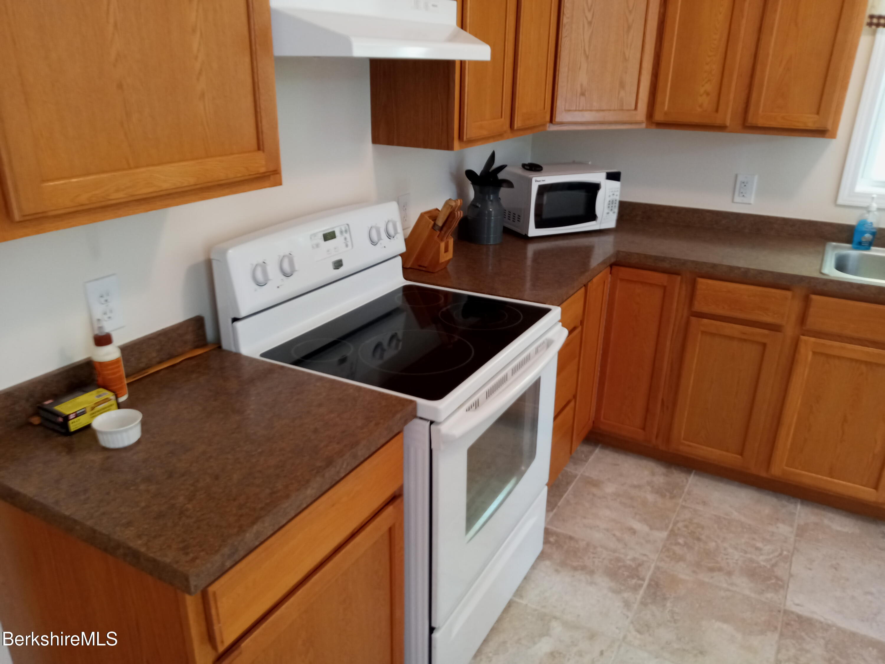 42 Norton Road Otis, MA 01029 - Photo 23 of 35 a kitchen with granite countertop cabinets washer and dryer