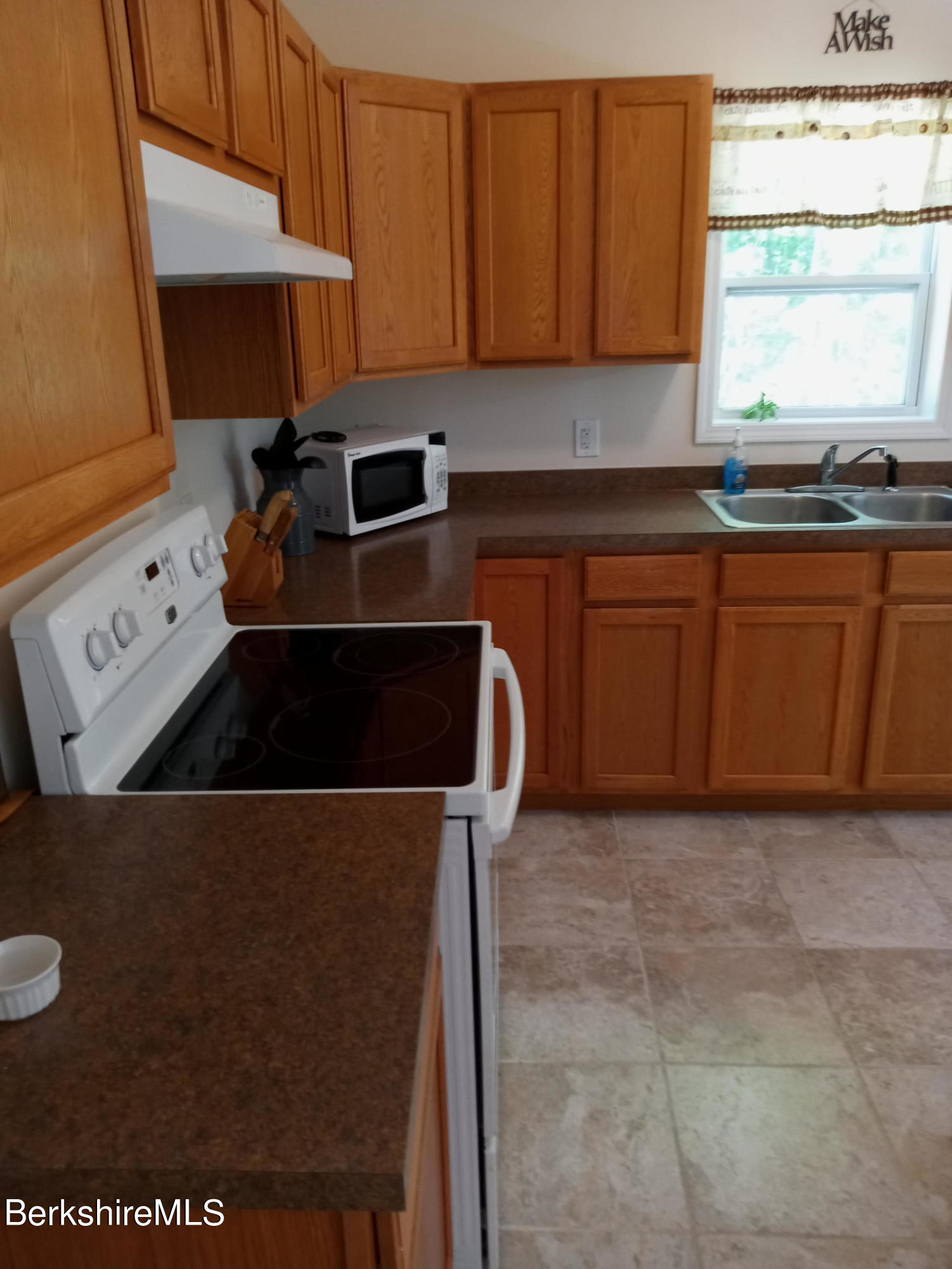 42 Norton Road Otis, MA 01029 - Photo 24 of 35 a kitchen with a stove a sink a counter top space and cabinets
