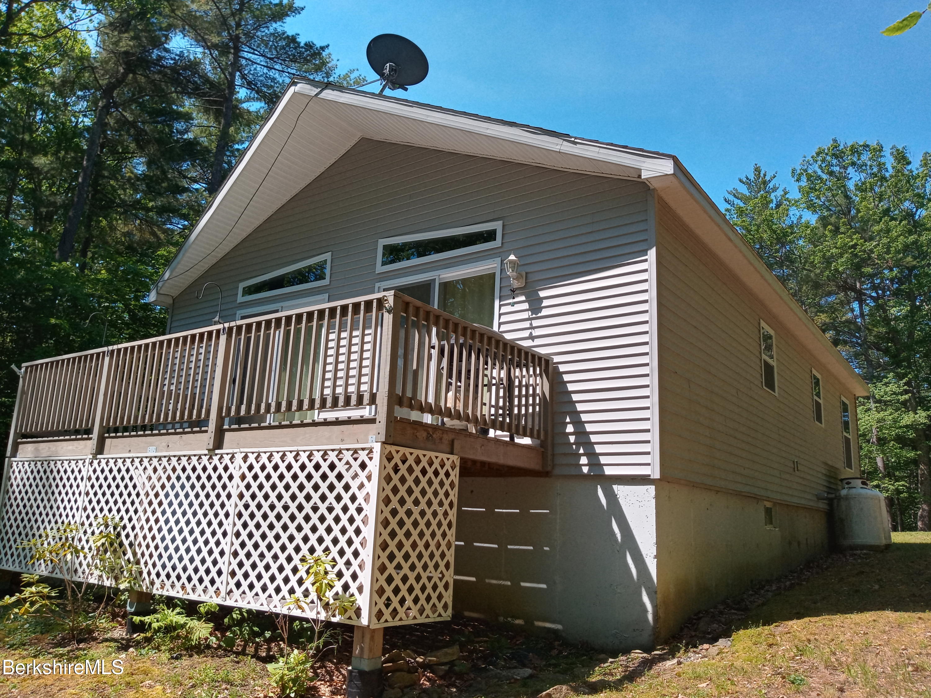 42 Norton Road Otis, MA 01029 - Photo 8 of 35 a view of a wooden house with a yard