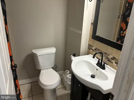 a white toilet sitting next to a bathroom sink