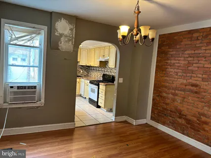a view of a livingroom with wooden floor and staircase