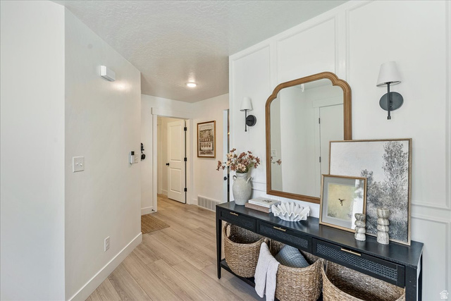 3916 South Sage Wood Avenue Mapleton, UT 84664 - Photo 6 of 33 Entryway featuring light wood-finish flooring, white walls, and a decorative console table