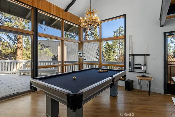 a room with pool table and windows